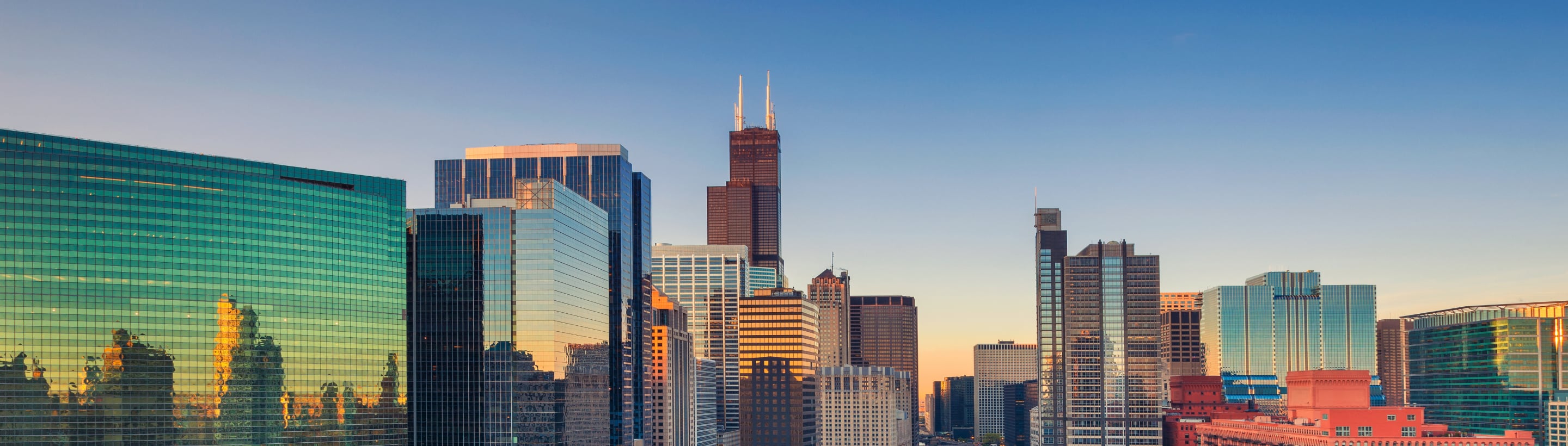 View of Chicago's financial district with high-rise buildings at sunset.