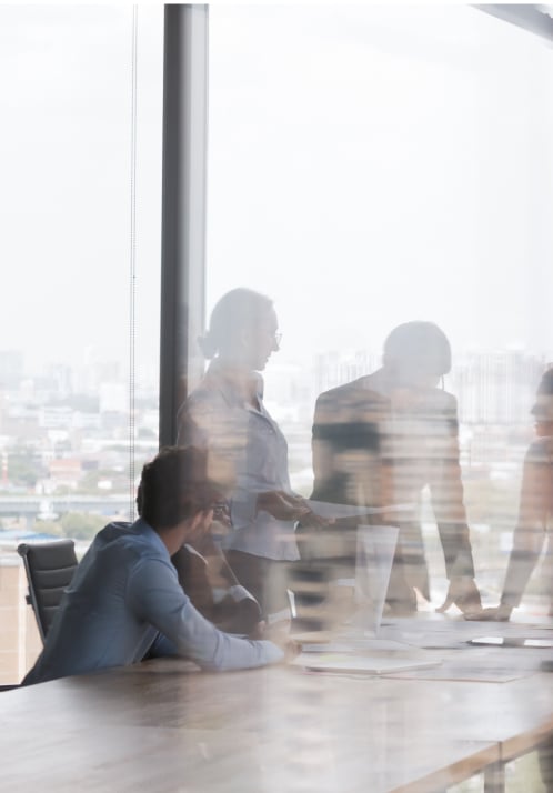 Twin Bridge team meeting reflecting the firm's expansion and growth in capital deployed.