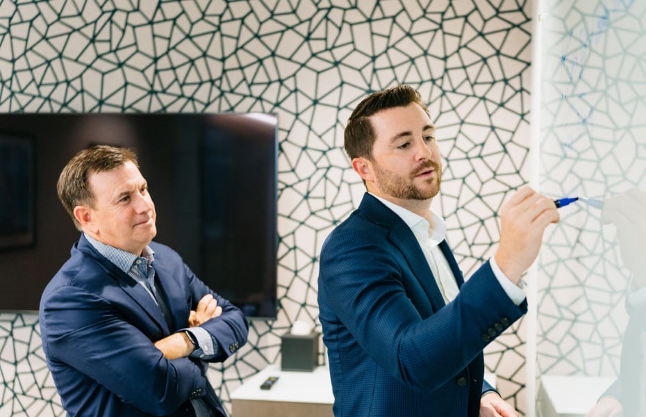 Twin Bridge team members collaborating during the launch of the Narrow Gate Series of Funds.